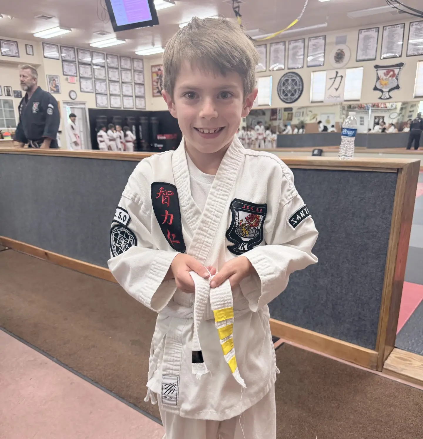 Ryker, receiving another stripe on his way to earning his yellow belt.